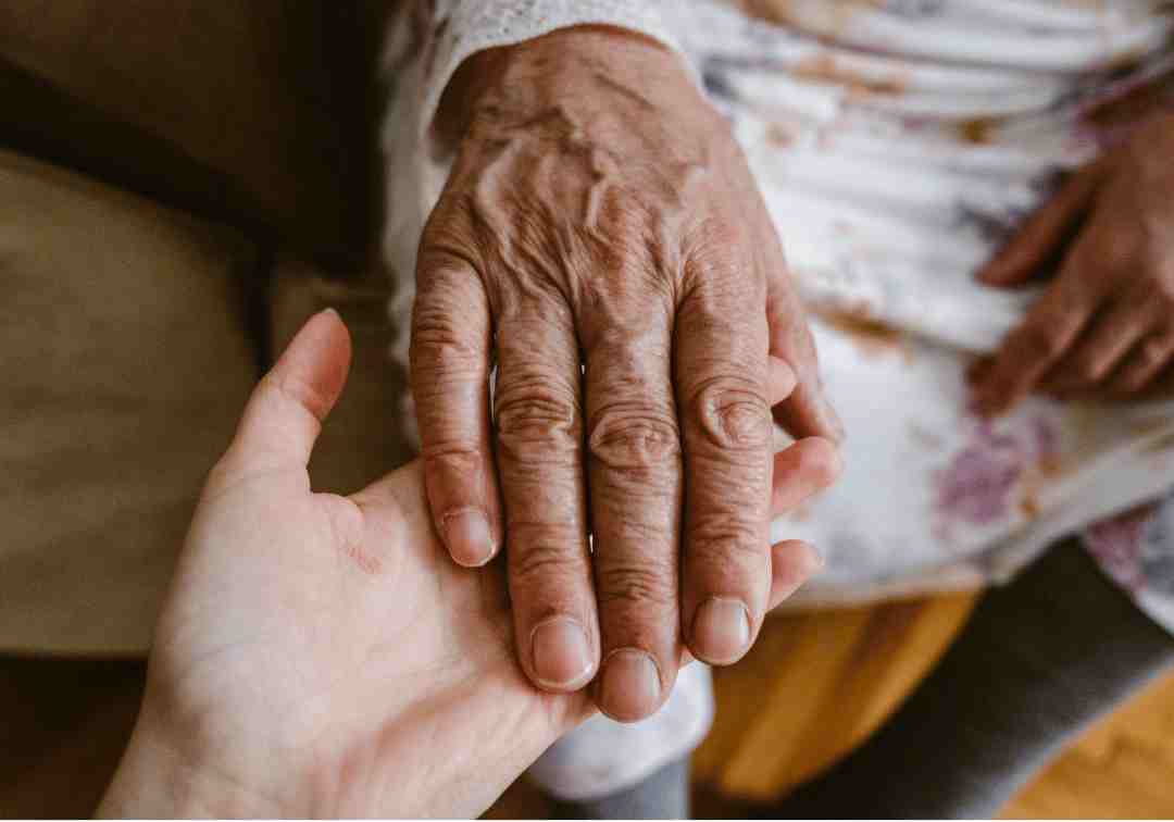 An older person receiving hand-in-hand support under the Support at Home program.