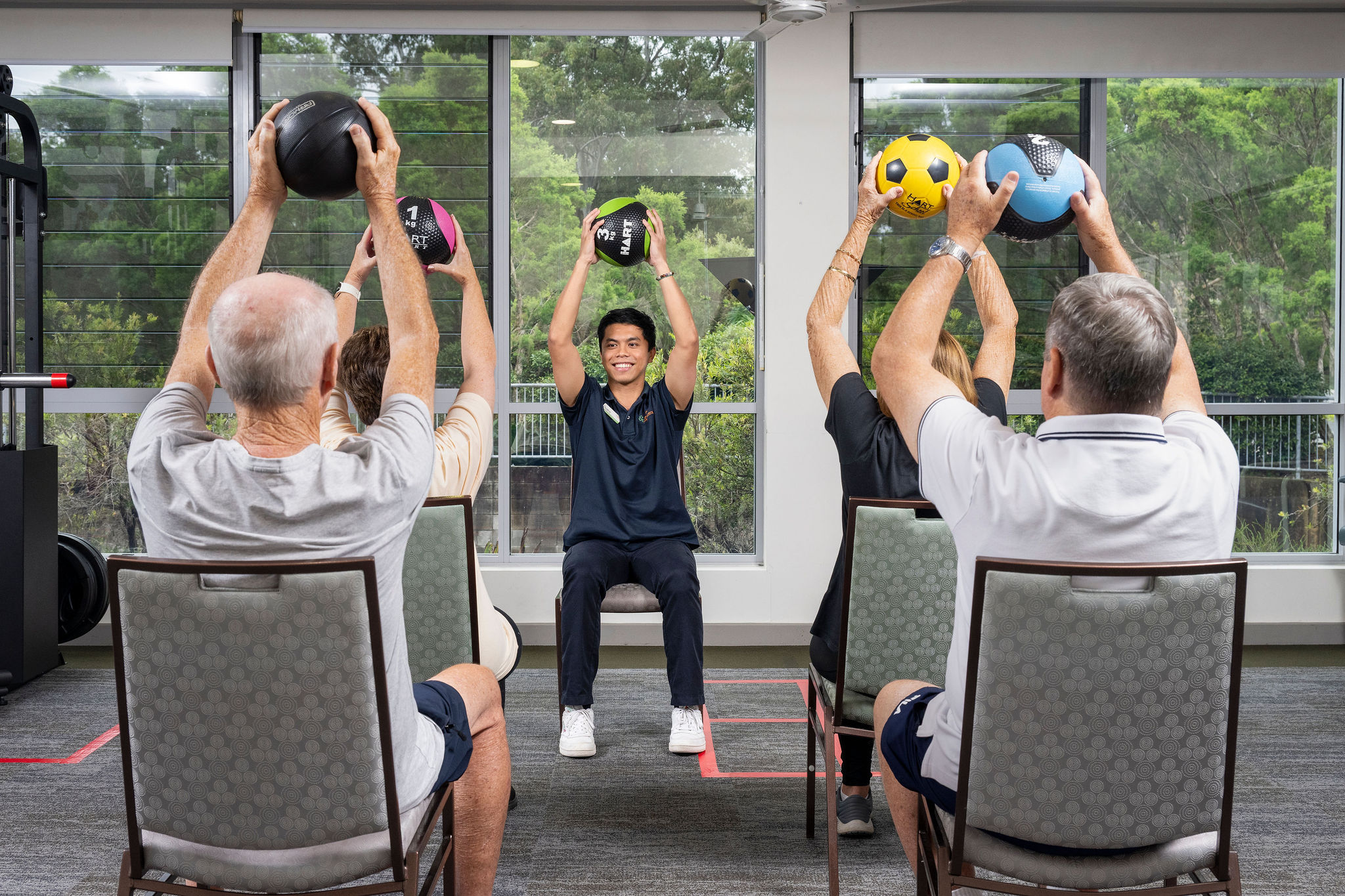 Active seniors participating in a guided exercise class at BallyCara's Wellness Centre in Scarborough.