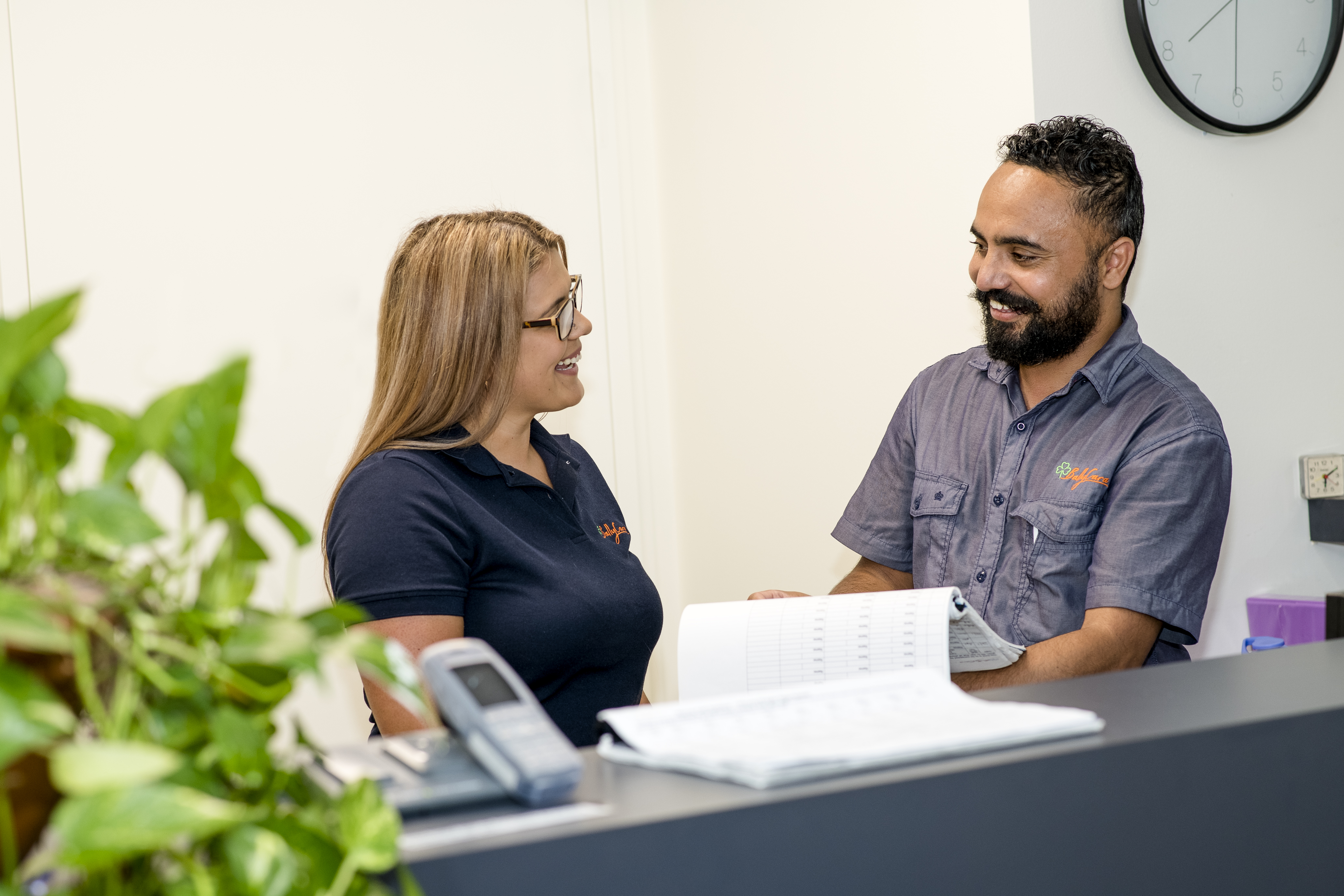 Two BallyCara employees engaged in a friendly professional discussion.