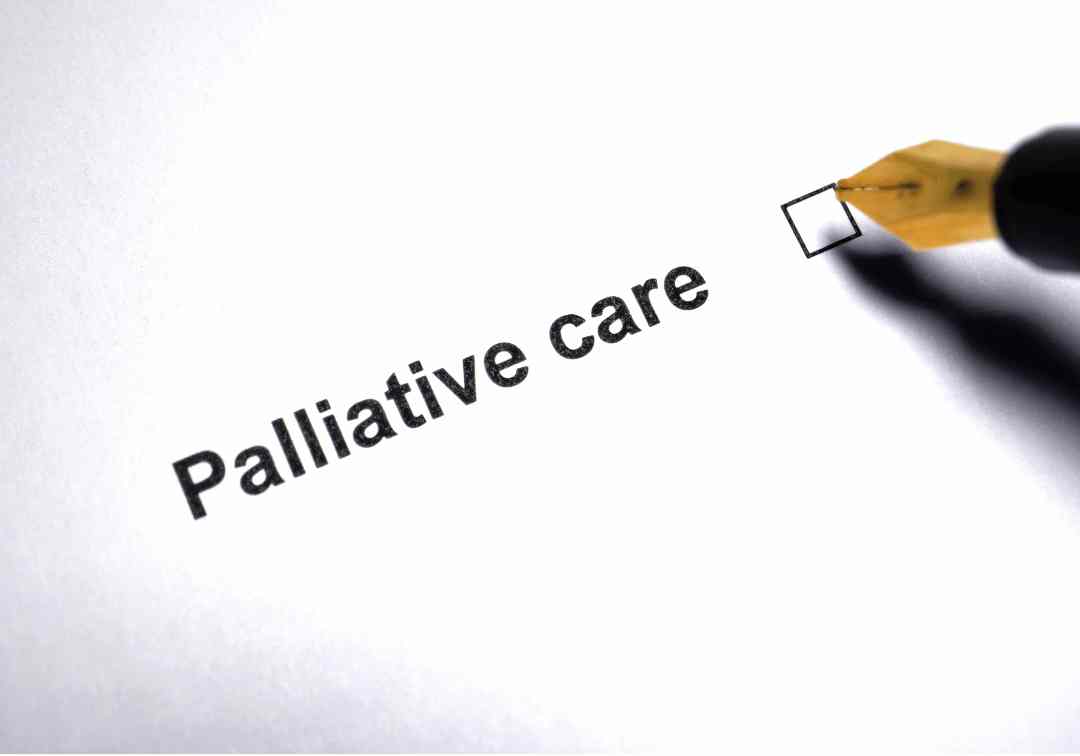 A pen hovering over a palliative care checkbox, representing personal choice and planning.
