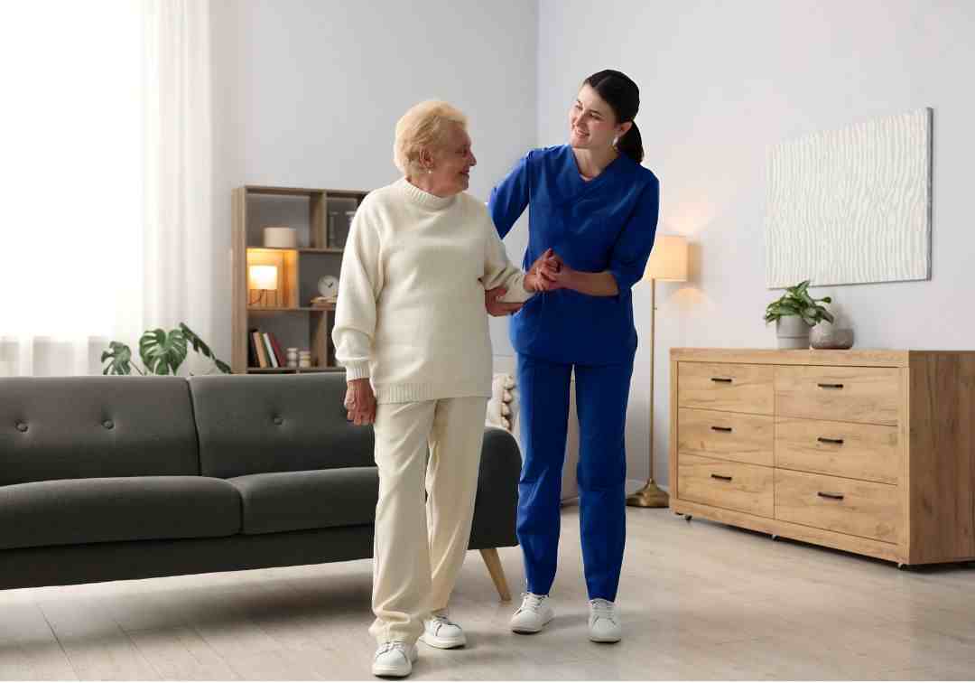 Health practitioner supporting a client in their home to regain independence through restorative care.